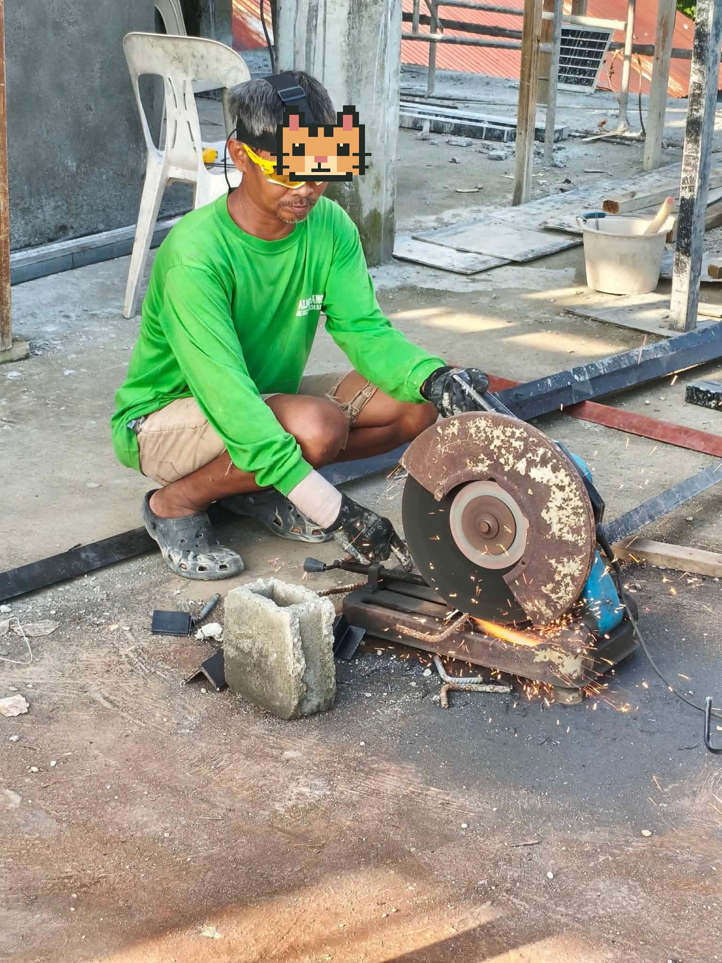 A metalworker cutting steel in an outdoor workshop