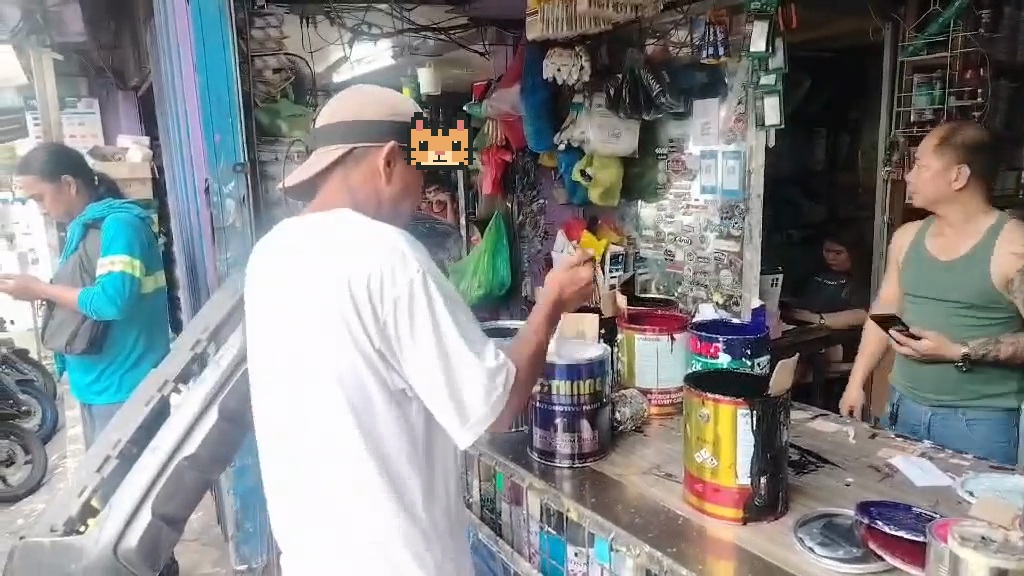A worker mixing paint