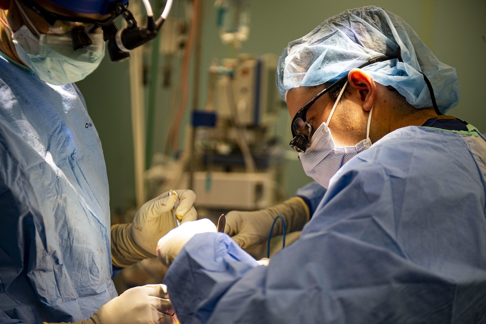 Surgeons performing surgery in an operating room