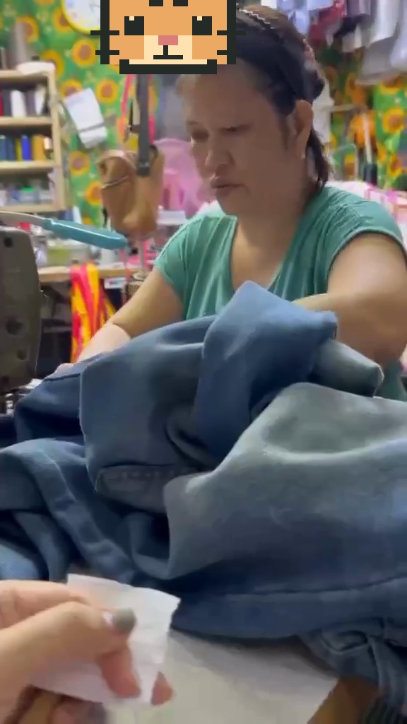 A tailor working with garments at a sewing machine
