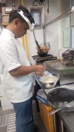 Chef at stove with quest headset
